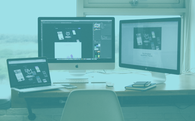 two computers and a laptop on a table